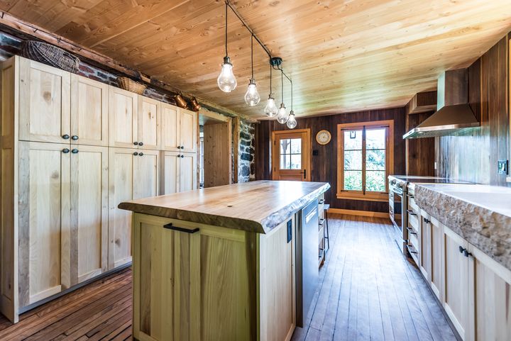 Light wood cabinets and island under a wood ceiling