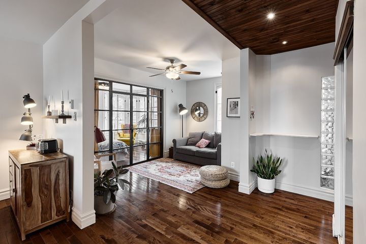 Black-framed glass wall between bedroom and living room