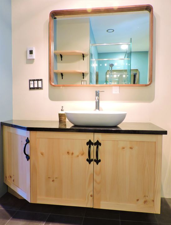 Knotty wood vanity with wrought-iron hardware